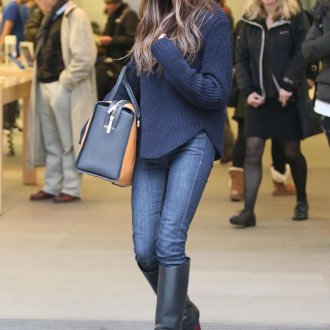 Уличный образ Виктории Бекхэм с джинсами, свитером и сапогами